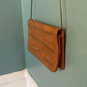 Leather cross body with metallic accents, metal chain for the detachable strap